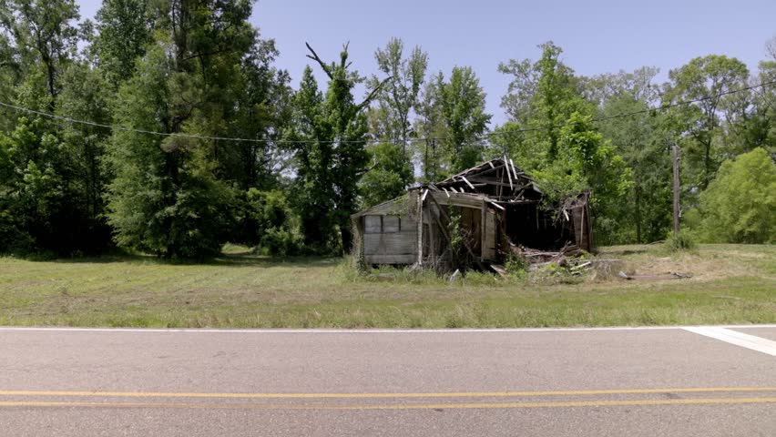 Abandoned house in rural Pine Hill, Alabama with gimbal video and truck passing by.