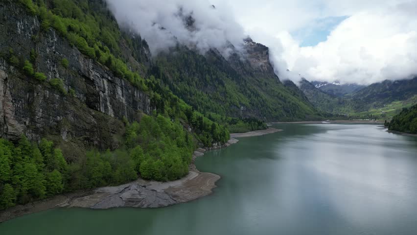 Stunning aerial view of clouds descending near Klontalersee lake 