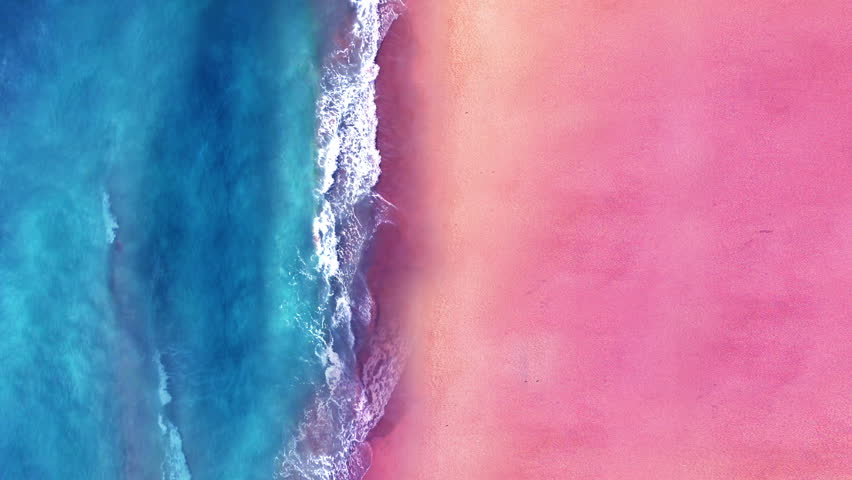 Aerial view of ocean waves break on tropical sand beach. Looping Water texture, Sea side and pink sand beach, Sunset  beach seamles loop background. Royalty-Free Stock Footage #1104781749
