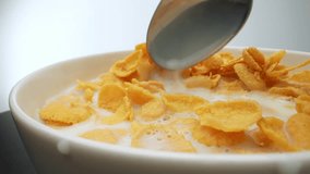 Capturing the tantalizing sight of crunchy corn flakes dancing in a sea of creamy milk. This macro video is a feast for the senses, showcasing the delectable essence of the perfect breakfast bowl. 4K
