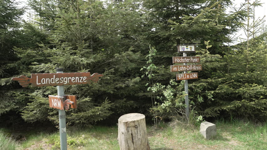 Signpost of the national border between Hessen and Northrine Westphalia in the Rothhaargebierge in Germany, also the highest point in the Lahnkreis.