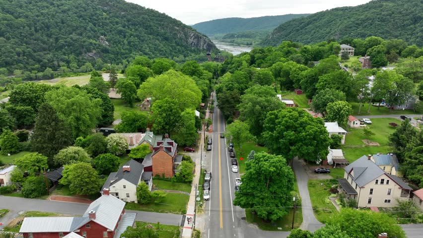 Shenandoah Mountains. Rising aerial reveals town on hillside. Harpers Ferry WV.