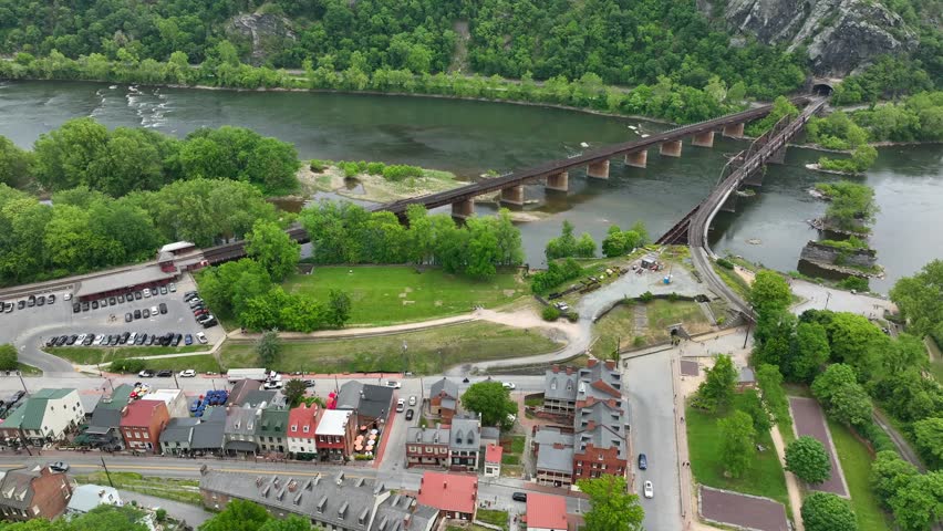 Railroad bridges with Shenandoah and Potomac Rivers. Historic buildings and railroad station. Aerial truck shot.