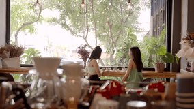 Slow motion, Close-up beautiful Asian woman's face, with spoon stir coffee cool it down before drinking coffee, but kept stirring coffee with spoon, release stress keep talking with friends in bakery. - Powered by Shutterstock - Get 15% off with code: PIKWIZARD15