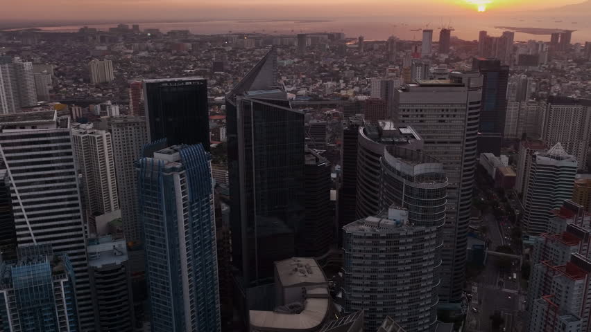 Flying Over The Skyscrapers Of Manila At Sunset, Philippines, Aerial View