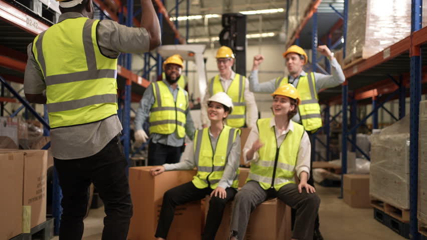 Happy warehouse workers celebrating success in warehouse factory Royalty-Free Stock Footage #1104796505