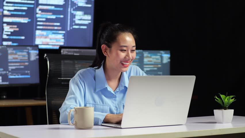 Asian Female Programmer Writing Code By A Laptop Using Multiple Monitors Showing Database On Terminal Window Desktops In The Office
 Royalty-Free Stock Footage #1104800435