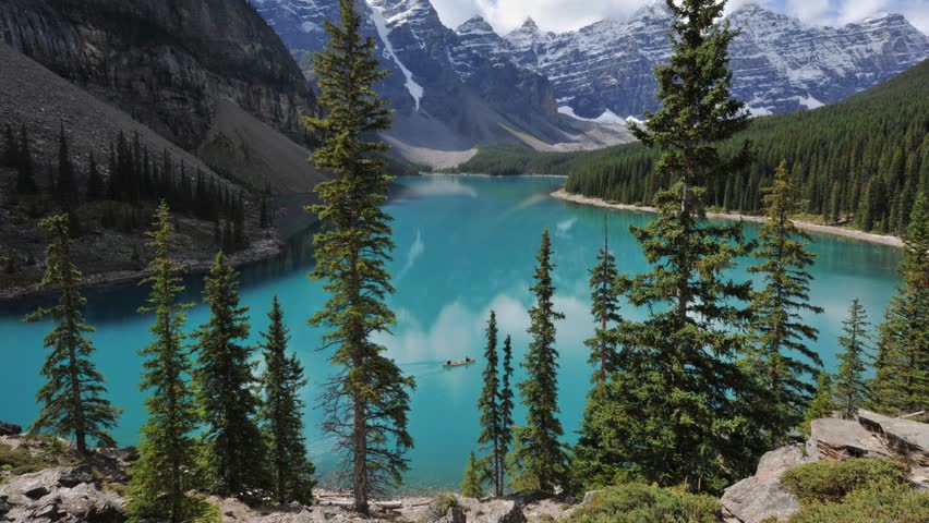 shot of Lake Moraine in Banff National Park. Mountains of famous Ten Peaks reflecting in the beautiful calm turquoise water of the lake. Banff National Park, Alberta province in Canada.
 Royalty-Free Stock Footage #1104802721