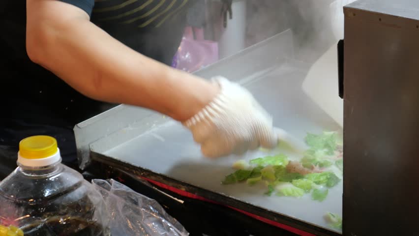 Street food at Raohe Street Night Market. It is one of the famous night markets in Taipei. Three are many food stalls and good dishes and snacks. 