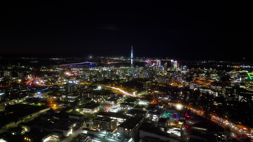 Auckland Skyline at Night. Aerial view, ascending upwards above the city. 