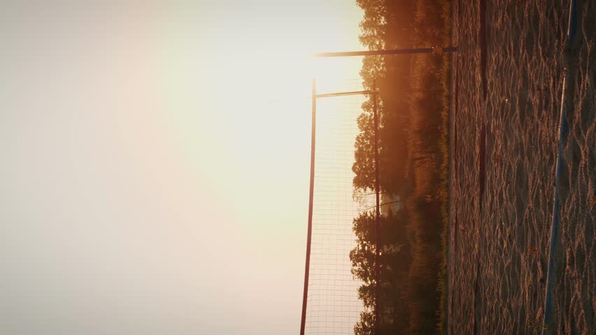 Beach volleyball field with net. Volleyball net silhouette on court. Vertical video. Empty beach volleyball sport field