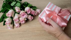closeup female hands holding box with gift, bouquet of white, pink roses, box with gift with satin ribbon, flowers for professional holiday, concept of mother's, Valentine's day, birthday - Powered by Shutterstock - Get 15% off with code: PIKWIZARD15