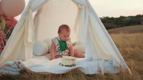 child's lifestyle. happy birthday in autumn field at sunset little kid in tent with cake. photographer shoots a birthday. family and baby joy.