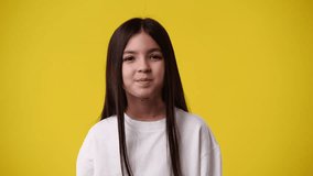4k video of one girl who posing and smiling over yellow background.