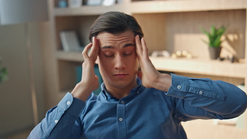 Overworked manager rubbing temples having headache at office closeup. Unmotivated freelancer taking break trying rest at modern workplace. Tired man suffering from migraine feeling discomfort alone | Shutterstock HD Video #1104814483