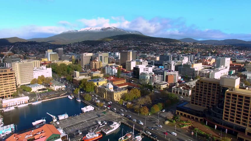 4K 24PS - Hobart, Tasmania CBD under snow-capped Mount Wellington from the air, tracking up