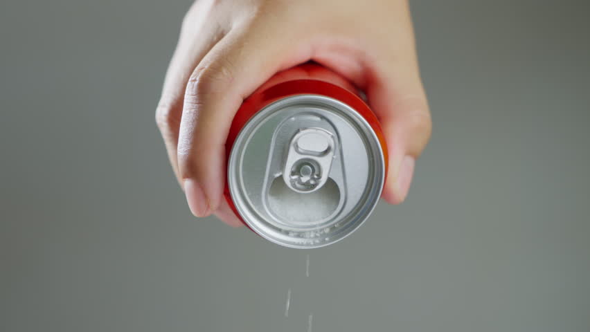 Unhealthy food - sugar in carbonated drinks. Red soda can pouring out white sugar showing an example of how bad and we all eat to much sugar. High amount of sugar in beverages. Slow motion. Royalty-Free Stock Footage #1104818983