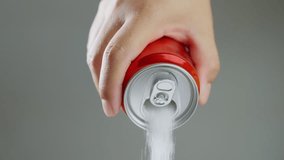 Unhealthy food - sugar in carbonated drinks. Red soda can pouring out white sugar showing an example of how bad and we all eat to much sugar. High amount of sugar in beverages. Slow motion. - Powered by Shutterstock - Get 15% off with code: PIKWIZARD15