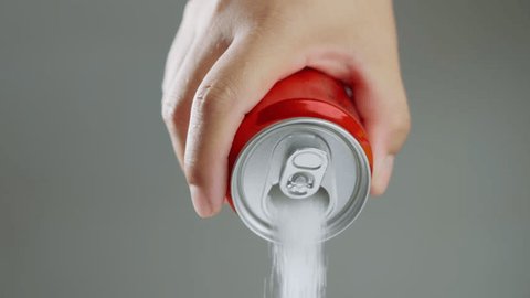 Unhealthy food - sugar in carbonated drinks. Red soda can pouring out white sugar showing an example of how bad and we all eat to much sugar. High amount of sugar in beverages. Slow motion. Video de stock