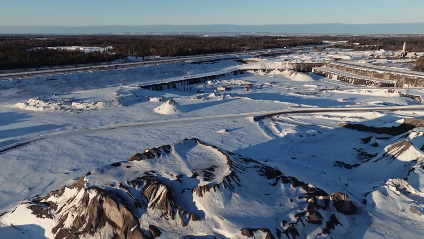 Drone shot of a snow covered limestone quarry mine at sunset in Ottawa Canada during winter