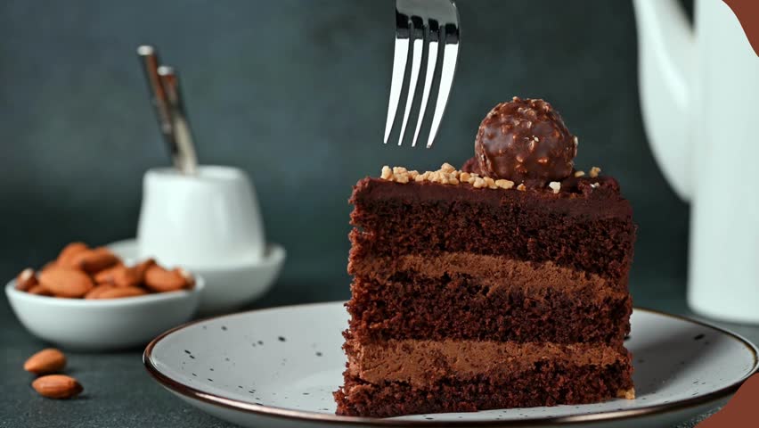 Biting a delicious piece of chocolate cake.
Eating chocolate cake. Taking ] a bite of moist delicious chocolate cake with a fork Royalty-Free Stock Footage #1104830807