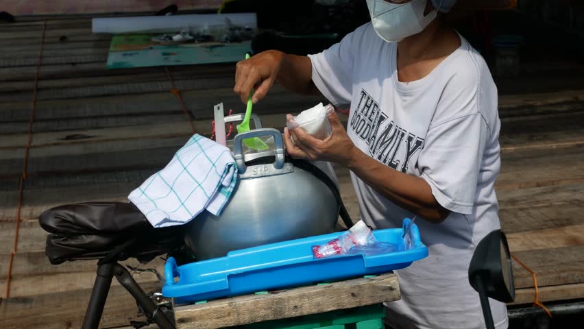 close up of traditional porridge seller bubur sumsum