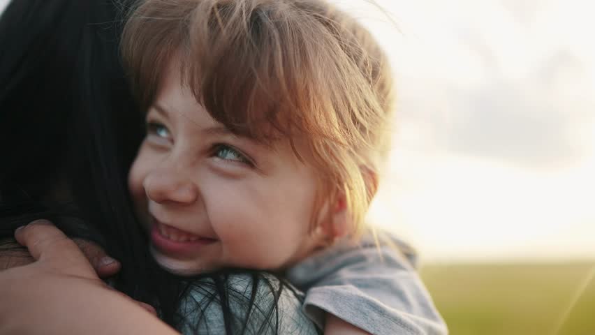 daughter hugging mom. happy family a kid dream concept. mother carries her daughter in her arms walk in the park in nature. child hugging mother lifestyle neck. mother walks with a child in nature Royalty-Free Stock Footage #1104831667