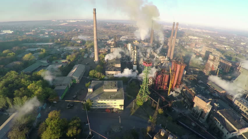 Chemical Factory with Smoke Stacks, captured by a Drone, showcasing the Environmental Impact of Industrial Pollution, aerial. | Shutterstock HD Video #1104831759