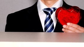 Businessman holding a heart and pointing - Powered by Shutterstock - Get 15% off with code: PIKWIZARD15