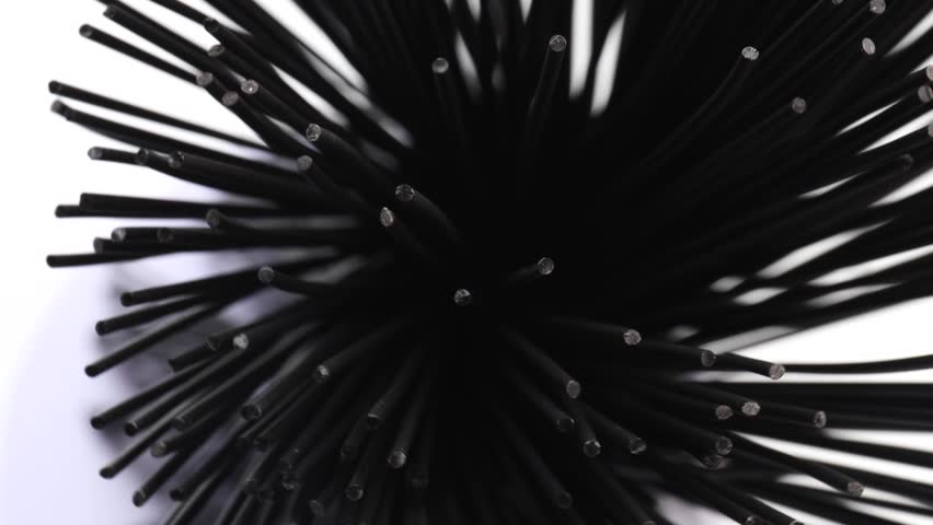 black spaghetti, rotation in circle. black abstract background, Turning. selective focus. spaghetti nero di seppia