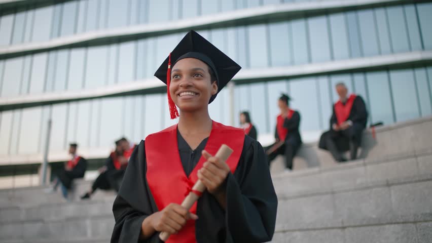 International university graduate celebrate, cheerful dark skinned woman graduates in a robes, rejoices at the end of her studies, an emotional moment, slow motion. | Shutterstock HD Video #1104836017