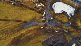 Vertical video: Majestic fields in icelandic countryside with black lands and roadside, nordic scenic route. Aerial view of spectacular frozen roads in scandinavian polar landscapes, wild nature.