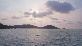 A video showing calm water currents on the ocean against an island in Thailand