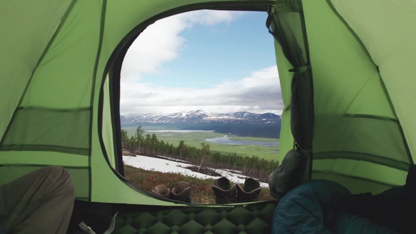 Inside of Hiking Tent with incredible View of Stunning Lake and Mountain and Landscape, Some Hiking Shoes in the Foreground, Camera tracking Inside-Out, Kungsleden Trail, Northern Sweden, Lapland