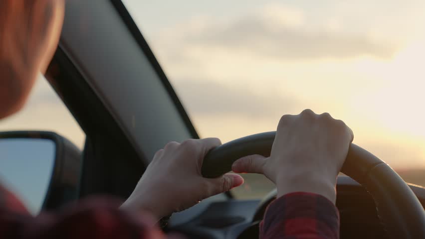 girl steering wheel car sunset. woman listens music car dances. sun light windshield. cheerful happy woman travels by car. smile girl dancing sitting front seat. pleasure traveling vacation. road car. Royalty-Free Stock Footage #1104841865