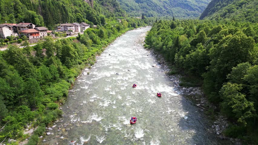 Go rafting on the river with dinghies immersed in the rapids of the stream and the nature of the canyon in Val Sesia Alagna Piedmont Alps mountains - drone view of summer water sport activities  | Shutterstock HD Video #1104844793