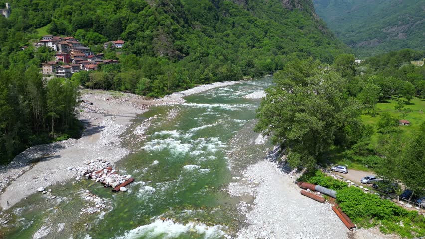 Drone flight over a wooden Tibetan suspended bridge that joins the river banks - view from the drone in Alagna Val Sesia Piedmont Alps mountains - travel concept journey in adventure natural trip  | Shutterstock HD Video #1104844799