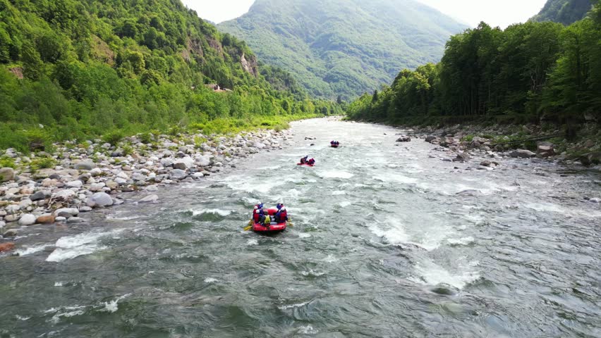 Go rafting on the river with dinghies immersed in the rapids of the stream and the nature of the canyon in Val Sesia Alagna Piedmont Alps mountains - drone view of summer water sport activities  | Shutterstock HD Video #1104844875