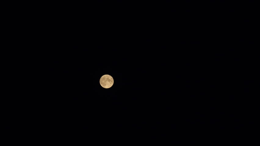 A glowing golden huge full moon seen from earth. Full moon rise in dark nature sky. Timelapse. | Shutterstock HD Video #1104847647