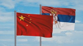 Republic of Serbia and China flag waving together in the wind on blue sky, cycle looped video, two country cooperation concept