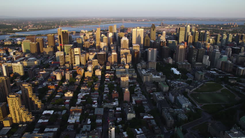 Aerial view overlooking the sunlit skyline of Montreal, summer sunset in Canada