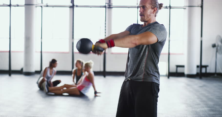 Weightlifting, kettlebell and man for cardio workout, bodybuilder training and exercise in gym. Fitness, sports and male person swinging weight for power, muscles and strength for wellness and health | Shutterstock HD Video #1104849605