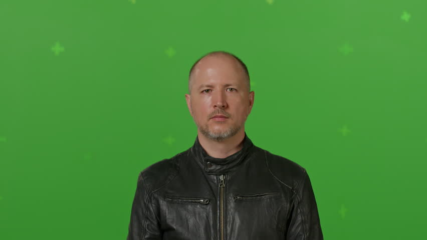 Close-up of Man Wears black full Face Motorcycle Helmet Before Riding a Bike. on green screen chroma key background. People, modern lifestyle and youth concept. | Shutterstock HD Video #1104850469