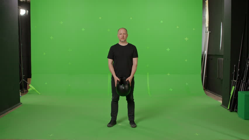 Man Wears black full Face Motorcycle Helmet Before Riding a Bike. on green screen chroma key background. People, modern lifestyle and youth concept. | Shutterstock HD Video #1104850481
