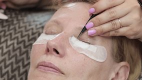 Cosmetic eyelash extension procedure in a beauty salon