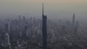 Aerial view hyperlapse 4k video of Kuala Lumpur city center view during dawn overlooking the city skyline in Federal Territory, Malaysia. Zoom out