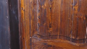 Close up shot of old wooden locked door with iron antique handle in ancient building. histotic, architecture. 4 k video