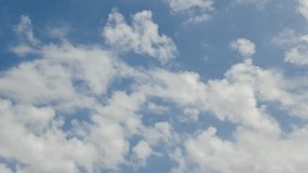 Time lapse video of white cumulus clouds moving on blue sky. Good summer weather. Beauty in nature. Copy space for your text. Natural backgrounds theme.