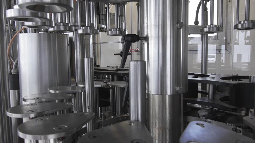 Mobile wine bottling and labelling machine components being tested without any bottles.