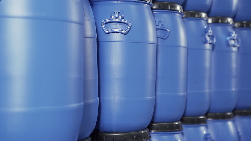 A close up group of Blue stacked Plastic chemical drums or Plastic Chemical barrels in the industrial warehouse. | Shutterstock HD Video #1104862653